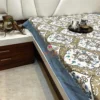 Corner view of Heirloom Damask bed sheet set highlighting blue border and all-over damask pattern on a bedroom setup