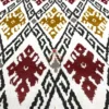 Closeup of Ikat Harmony bed sheet pattern with rich maroon, mustard, grey, and red ikat motifs for a textured effect.