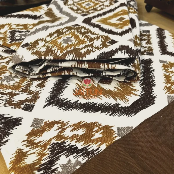 Closeup of Kalahari Ikat Geometric Bed sheet Set showing brown, mustard, and grey ikat pattern on crisp white fabric