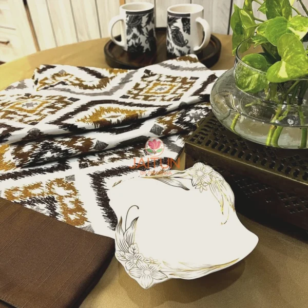 Kalahari Ikat Geometric Bed sheet Set styled with green plant and ceramics, highlighting geometric ikat design and brown border