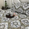 Siena Heritage Damask Bed Sheet Set spread on bed with coordinated pillow covers and tray of mugs, highlighting elegant floral motifs