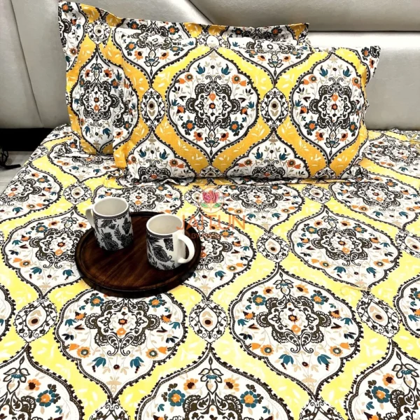 Close view of Sunshine Elegance Yellow Bloom bed sheet showing pillows and detailed floral print in a bright yellow palette.