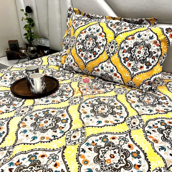 Sunshine Elegance Yellow Bloom bed sheet neatly spread on the bed with matching pillows and a wooden tray with mugs for a cozy setup.