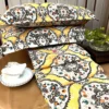 Sunshine Elegance Yellow Bloom bed sheet and pillow arrangement showcasing coordinated vibrant bedding with detailed floral design.