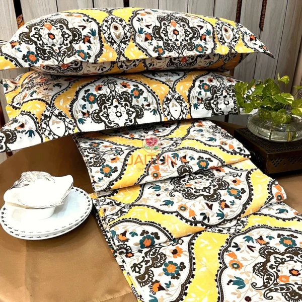 Sunshine Elegance Yellow Bloom bed sheet and pillow arrangement showcasing coordinated vibrant bedding with detailed floral design.
