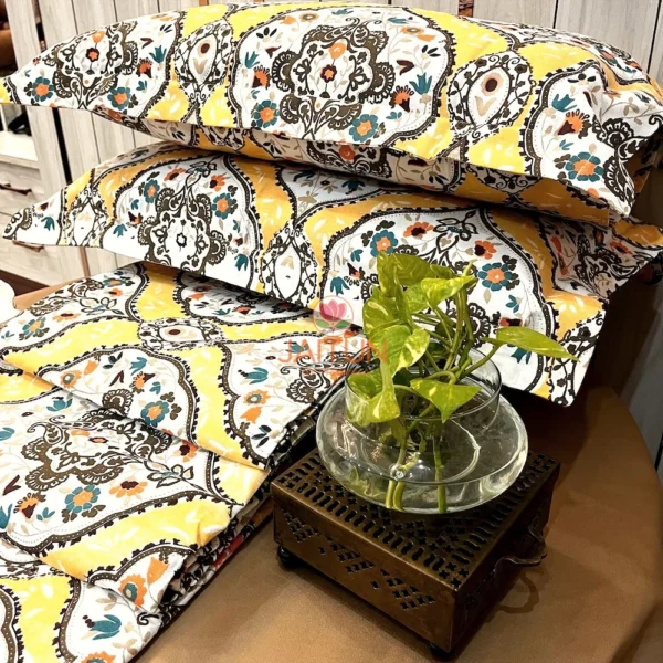 Sunshine Elegance Yellow Bloom bed sheet set adorned with a green indoor plant, highlighting the lively decor style.