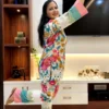 Playful pose in Tropical Bloom Co-ord Set showing colorful stripes and floral style