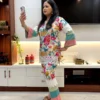 Model posing in Tropical Bloom Co-ord Set while taking a selfie, featuring vibrant patterns