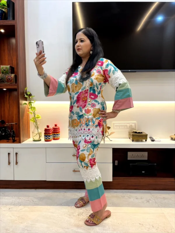 Model posing in Tropical Bloom Co-ord Set while taking a selfie, featuring vibrant patterns