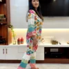 Side profile of model in colorful Tropical Bloom Co-ord Set with floral and pastel design