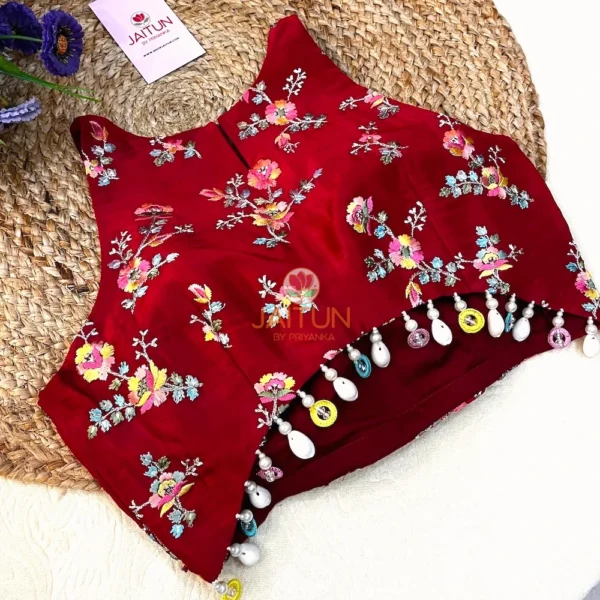 Full display of Crimson Bloom Hand-Embroidered Wedding Blouse as part of a bridal ensemble, featuring rich embroidery, pearl adornments, and festive elegance.
