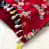 Side view of Crimson Bloom Hand-Embroidered Blouse showing multicolor beads and pearl drops on the hem for bridal elegance and festive charm.