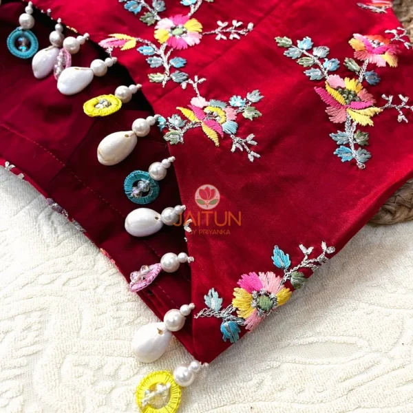 Side view of Crimson Bloom Hand-Embroidered Blouse showing multicolor beads and pearl drops on the hem for bridal elegance and festive charm.