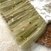 Close-up of olive green tulle peplum with sequins on Designer Olive Garden Brocade Blouse, ideal for bridal and wedding wear.
