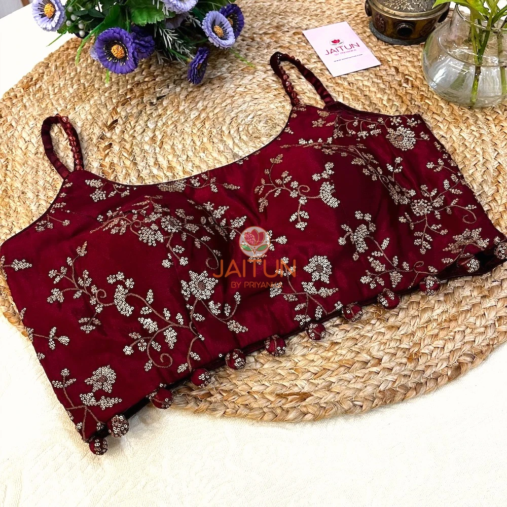 Full display of Maroon Regal Bloom Embroidered Blouse with golden embroidery, spaghetti straps, and bead tassels, designed for weddings and festive celebrations.