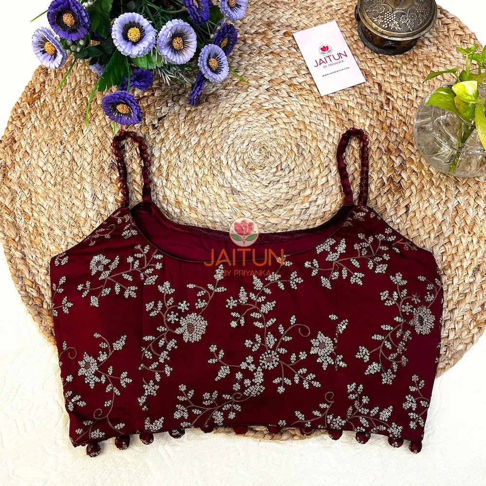 Side view of Maroon Regal Bloom Embroidered Blouse with detailed golden embroidery and bead tassels, perfect bridal and festive attire. A wedding collection blouse
