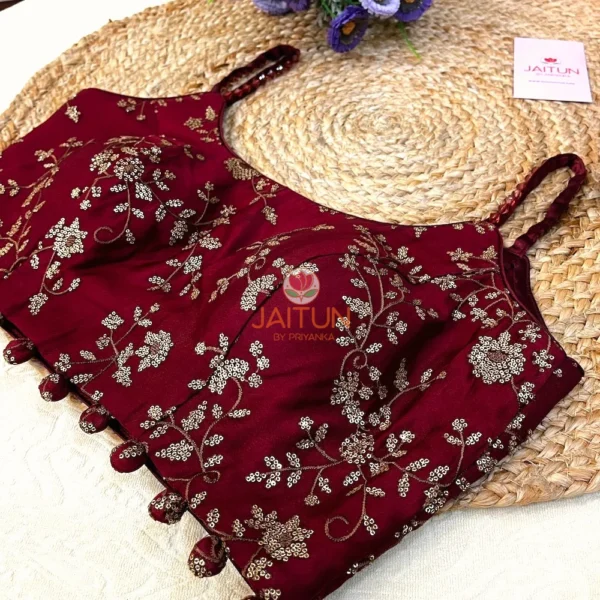 Detail shot of bead tassels and embroidered hemline on Maroon Regal Bloom Bridal Blouse in rich maroon, highlighting luxury craftsmanship.