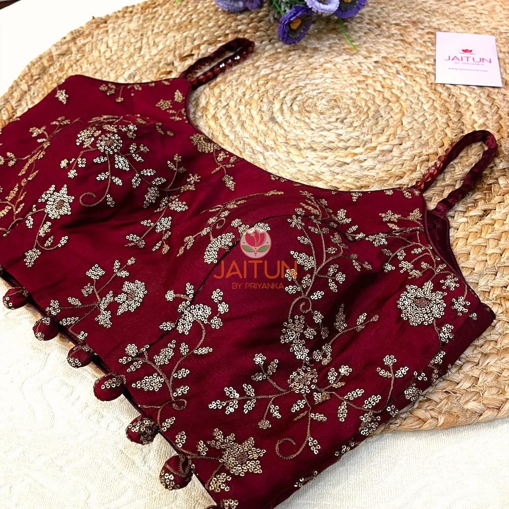 Detail shot of bead tassels and embroidered hemline on Maroon Regal Bloom Bridal Blouse in rich maroon, highlighting luxury craftsmanship.