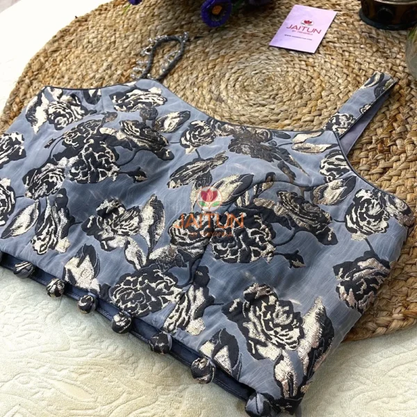 Detail of fabric button hemline and gold floral accents on the Midnight Bloom Metallic Wedding Blouse, ideal for bridal and festive ensembles.