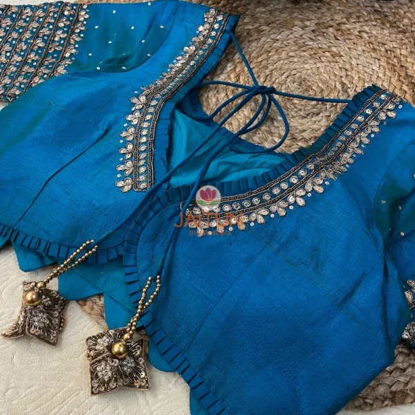 Back view of Royal Blue Kundan Silk Blouse showing tie-back strings with decorative tassels and elegant silk craftsmanship.