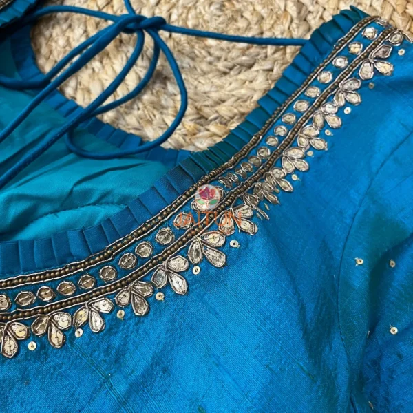 Close-up of kundan adorned neckline on Royal Blue Silk Blouse, featuring traditional bridal embellishments for the wedding collection.