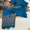 Focus on the peplum edge of Royal Blue Kundan Silk Blouse with scalloped hem and kundan embroidery, suitable for wedding functions.