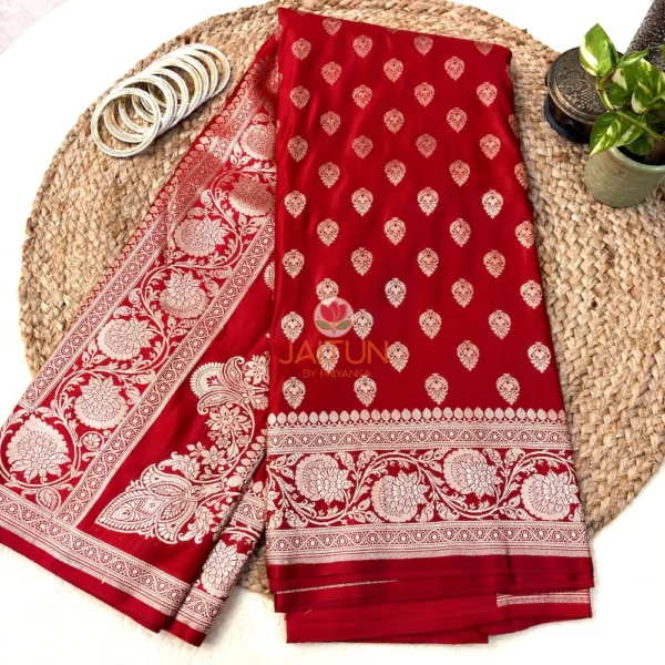 Close-up of floral antique gold zari border on red Banarasi silk saree, highlighting traditional weaving technique