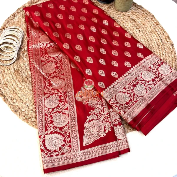 Regal red Banarasi silk saree display with antique gold zari floral border and elegant motifs, styled for wedding and festive wear
