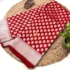 Regal Red Pure Banarasi Silk Saree full length display with bangles and planter Full length Regal Red Pure Banarasi Silk Saree laid out on woven mat with golden bangles and green plant styled beside it