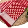 Regal Red Pure Banarasi Silk Saree product flatlay with price tag and accessories Product flatlay of Regal Red Pure Banarasi Silk Saree with golden bangles, decor props and visible price tag on woven mat