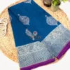 Full shot of teal blue pure Banarasi silk saree with silver zari paisley border and contrast purple edge.