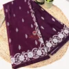 Folded deep wine Banarasi silk saree with silver zari floral border and pallu detailing.