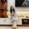 Woman wearing Floral Bloom Co-Ord Set in ivory white and blue floral print with lace detailing, sitting pose front view