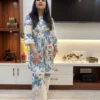 Front walking view of Floral Bloom Co-Ord Set in ivory white and blue floral print with lace-trim trousers
