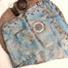Nooré Celeste Organza Silk Saree Flat Lay Flat lay view of Nooré Celeste luxury organza silk saree featuring floral zari weaving, handcrafted mirror motif and embroidered scalloped border.