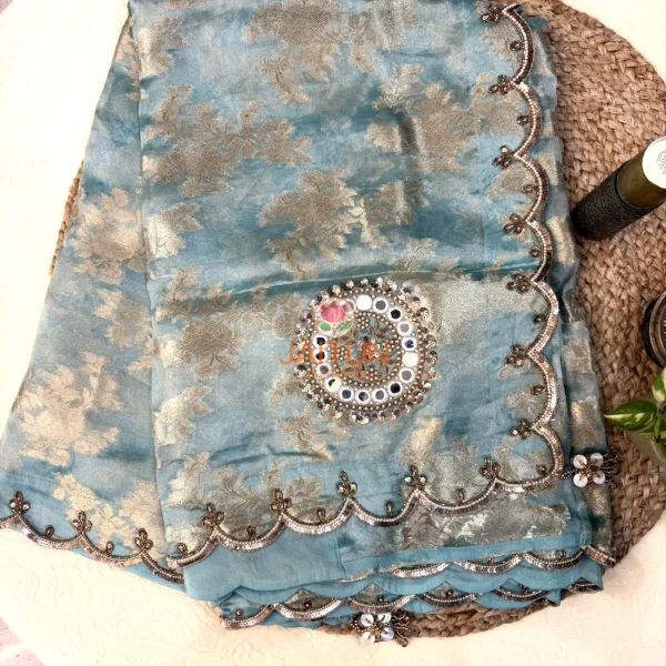 Full view of Nooré Celeste premium organza silk saree with floral zari motifs, ornate mirror work and handcrafted embroidered scalloped border by Jaitun by Priyanka.