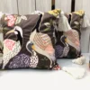 Pair of Crane Garden Cushion Covers featuring embroidered crane bird artwork and botanical floral design.