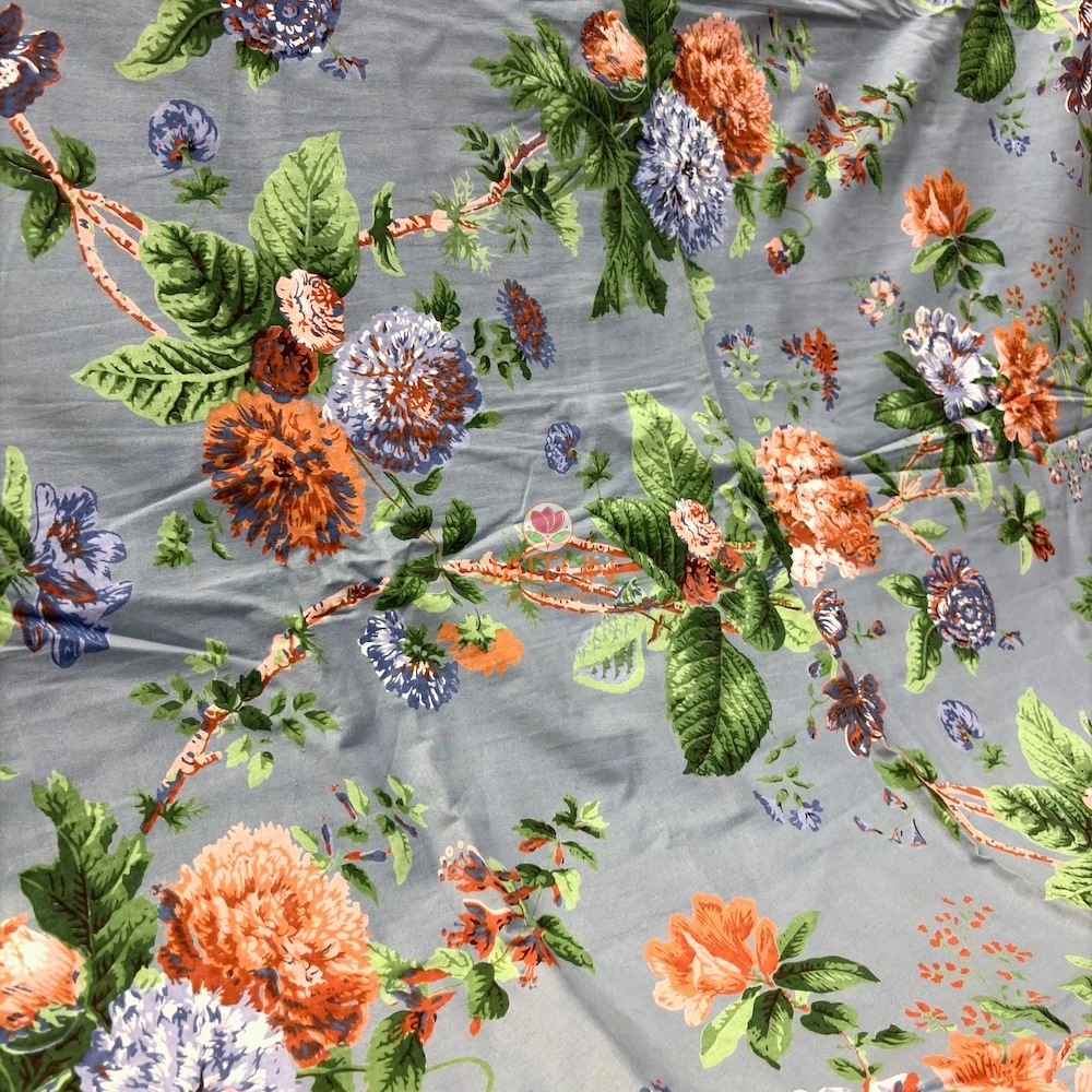 Bluebell Blossom Bedsheet – Botanical Print Detail Close-up of Bluebell Blossom bedsheet showing orange and blue flowers with green botanical leaves