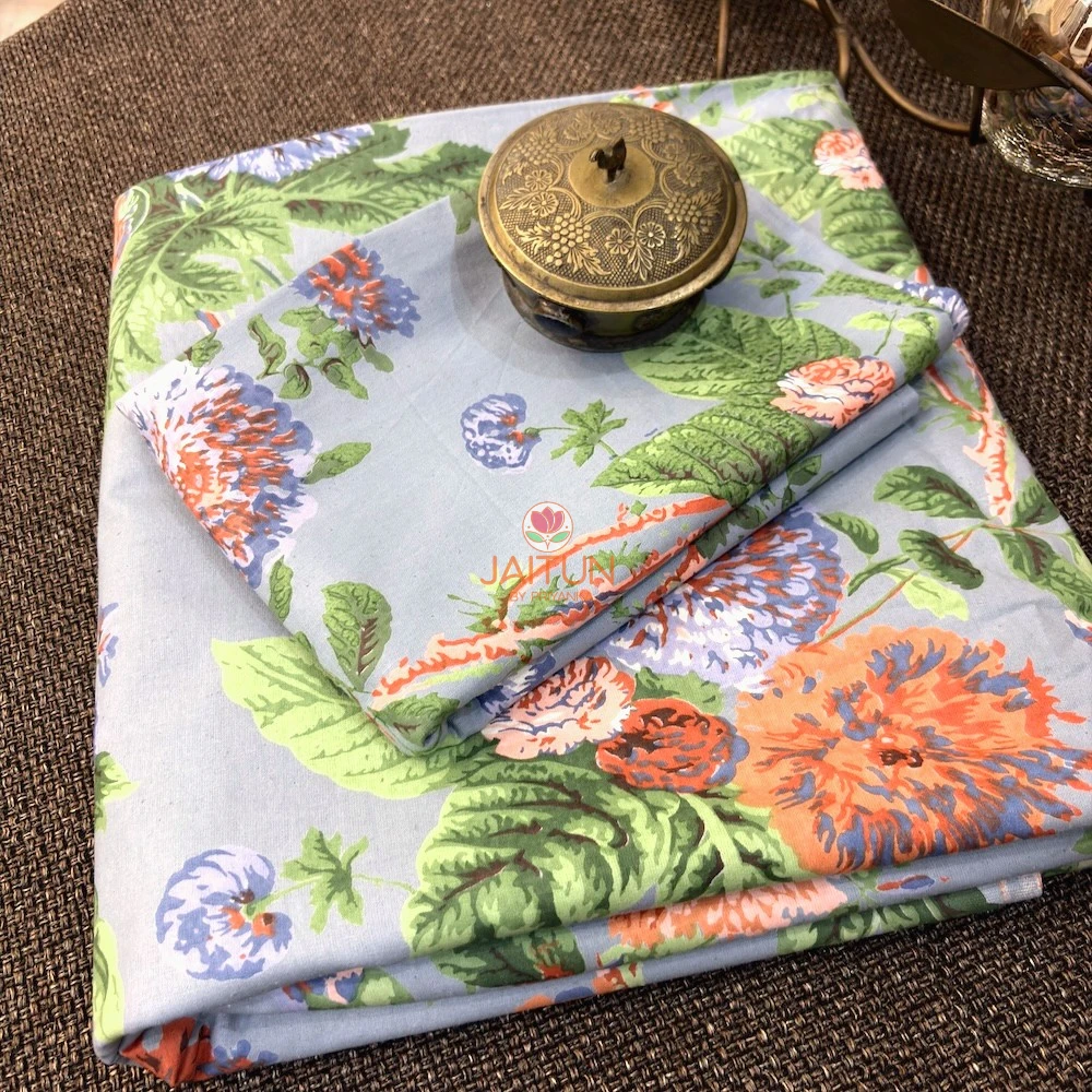Bluebell Blossom Double Bedsheet – Folded View Folded Bluebell Blossom double bedsheet featuring blue, orange and green floral botanical print