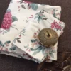 English Garden Bedsheet – Folded Detail View English Garden printed bedsheet folded view showcasing elegant pink flowers and green leaves