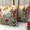 Flora Royal embroidered floral cushion covers styled together with colorful botanical artwork and luxury finish