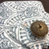 Close-up of Indigo Fern Bedsheet showing detailed indigo floral and fern motifs on ivory fabric