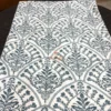 Indigo Fern Bedsheet neatly folded to showcase its intricate botanical print and fabric design