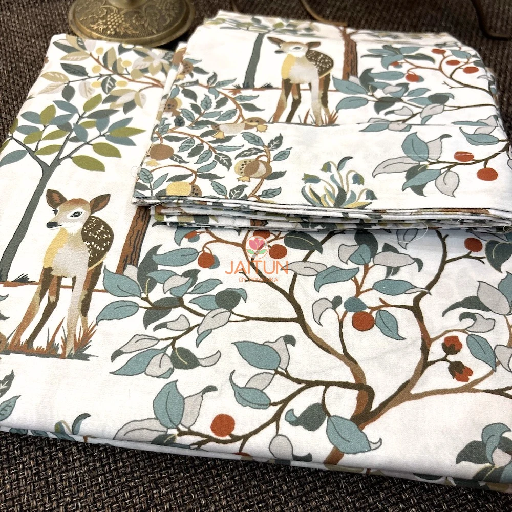 Little Deer Meadow Bedsheet – Folded View Little Deer Meadow printed bedsheet featuring deer, trees and botanical motifs