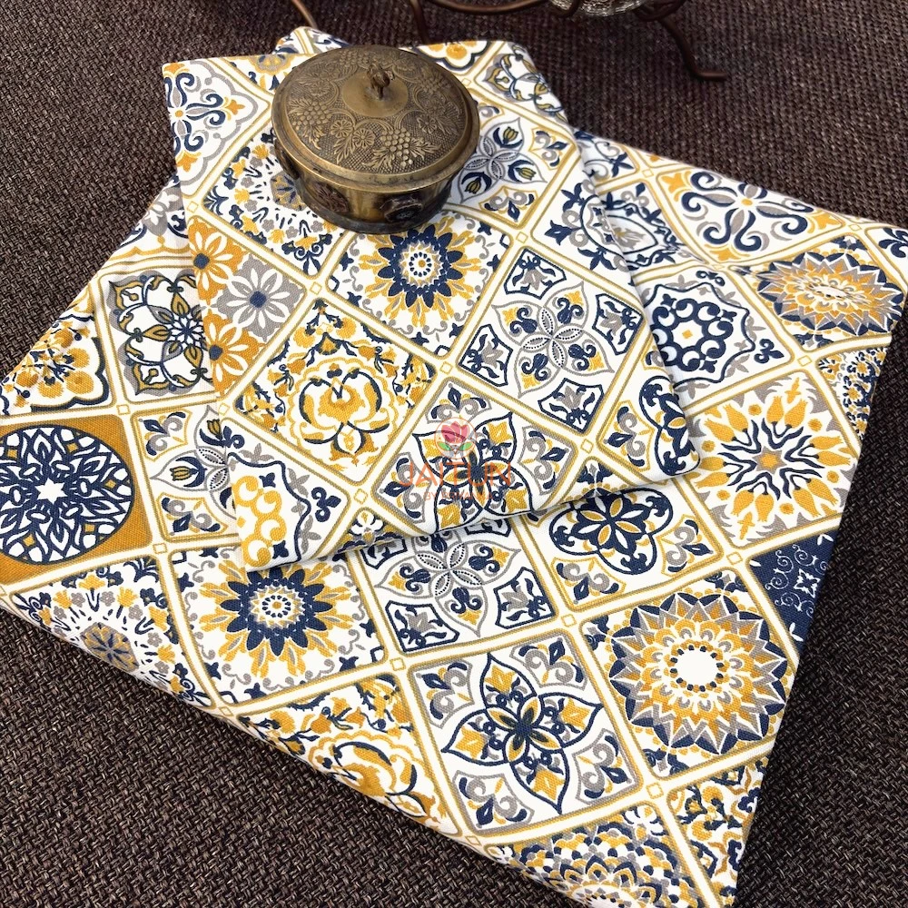 Folded Mediterranean Mosaic Bedsheet featuring navy blue and mustard tile-inspired prints