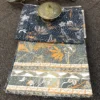 Midnight Botanica bedsheet featuring grey botanical design, navy floral print and decorative striped border