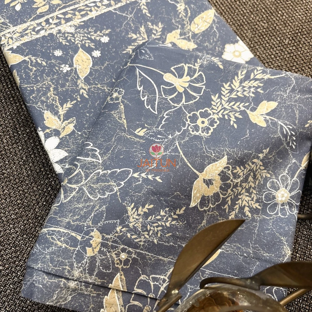 Close-up of Moonlit Meadow bed sheet featuring beige floral and botanical motifs on a slate blue base