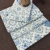 Folded Moroccan Mist Bed Sheet featuring blue, sage and ivory Moroccan tile motifs