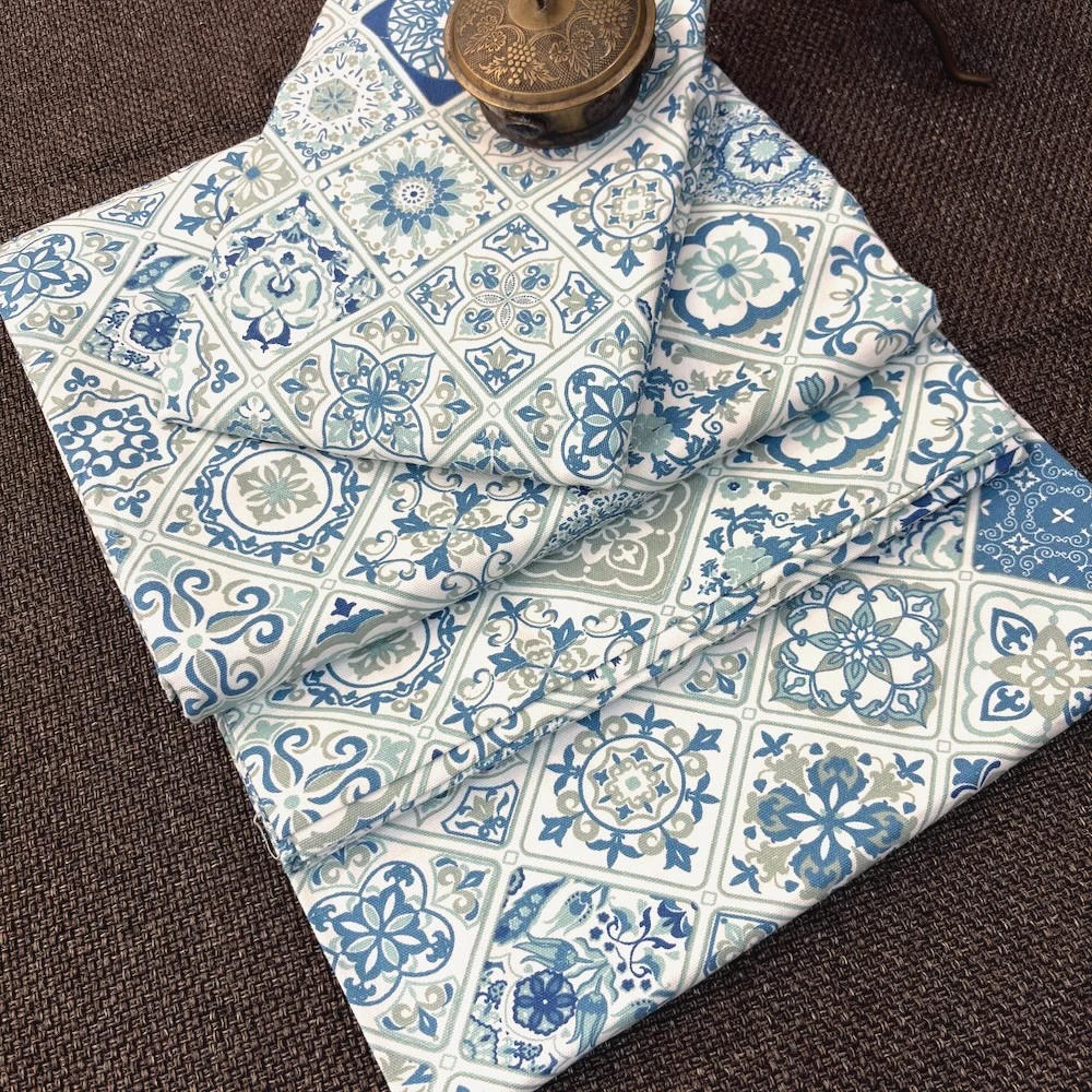 Folded Moroccan Mist Bed Sheet featuring blue, sage and ivory Moroccan tile motifs