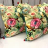 Angled view of Emerald Peacock Blossom Embroidered Cushion Covers showcasing intricate embroidery and floral detailing